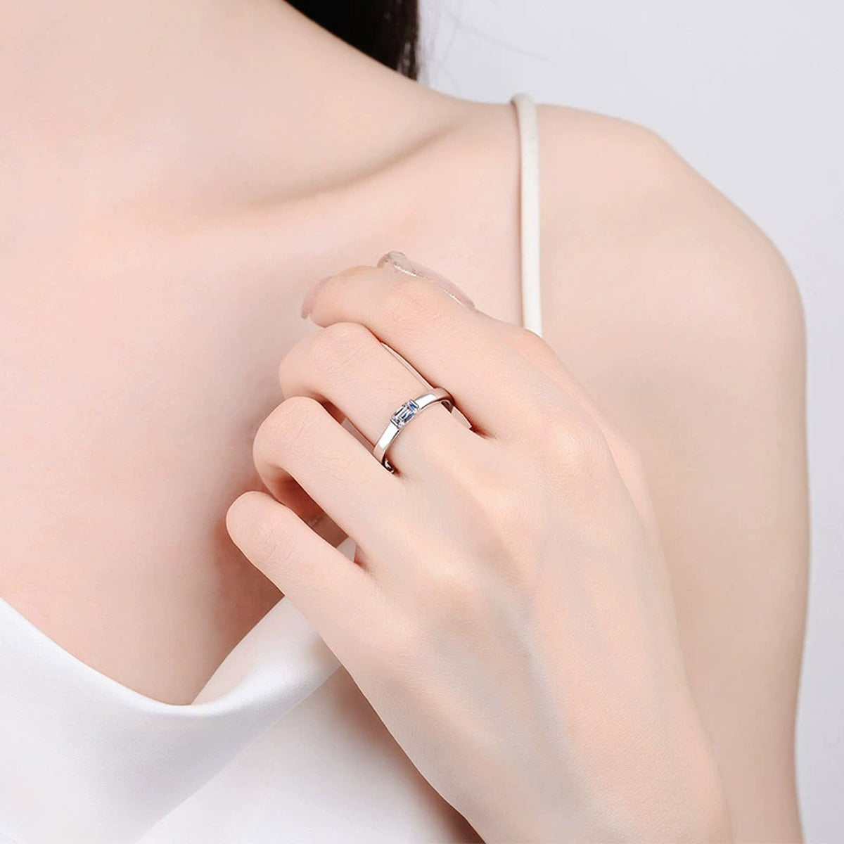 Emerald Cut Moissanite Band Ring worn on hand to show scale, band width, and ring profile