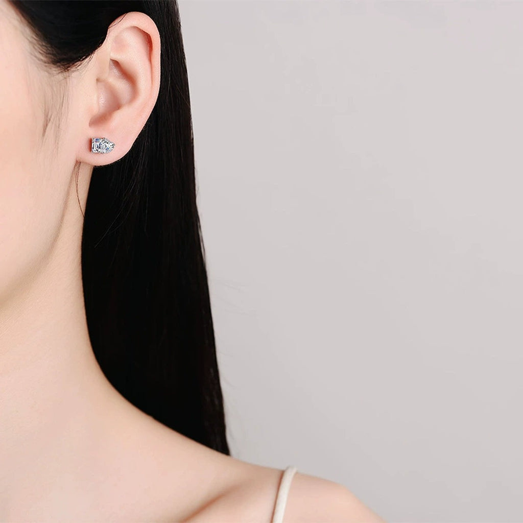 Heart and Rectangular Cut Moissanite Stud Earrings in Rhodium-Plated S925 sterling silver worn on ear by model showing scale, placement, and stud earrings styling