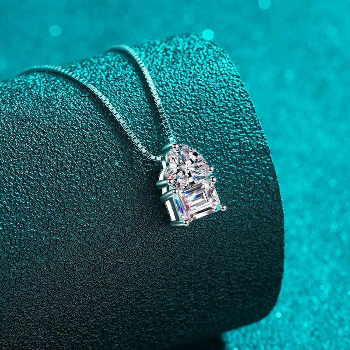 Heart Emerald and Radiant Cut Moissanite Pendant Necklace in Rhodium-Plated S925 sterling silver blue display scene showing chain and stone layout