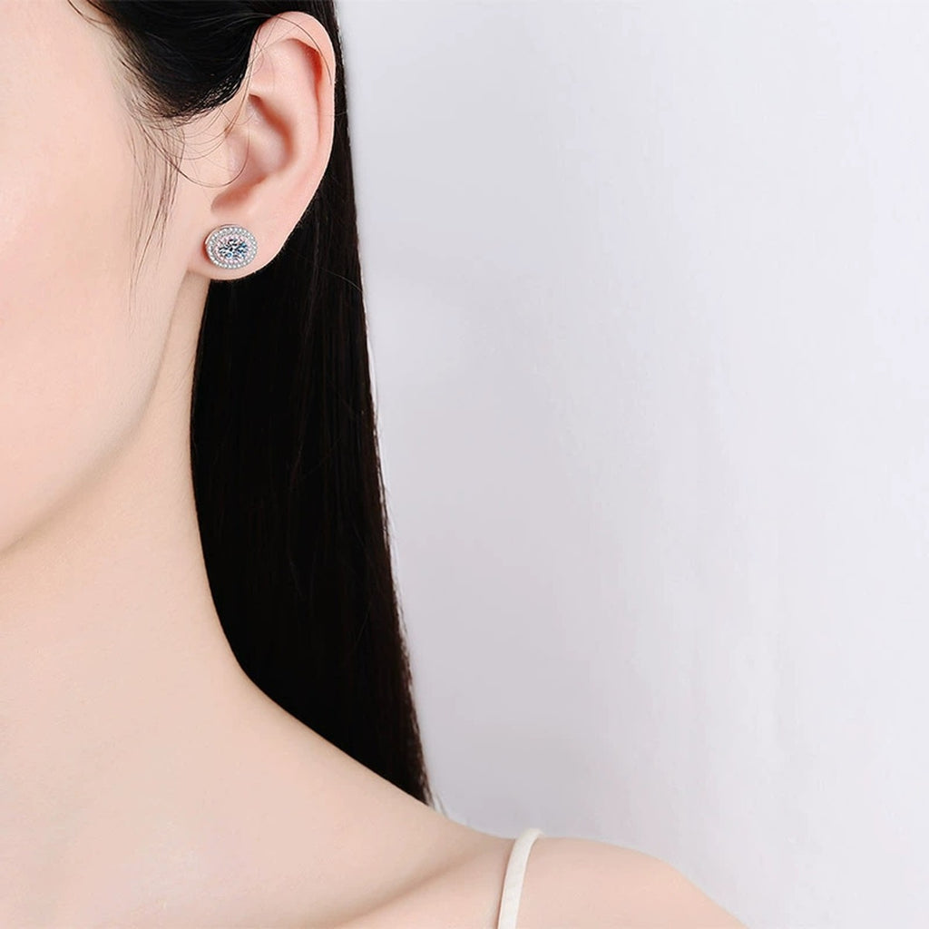Oval Moissanite Stud Earrings with Pink CZ in Rhodium-Plated S925 sterling silver worn on ear by model showing scale, placement, and stud earrings styling