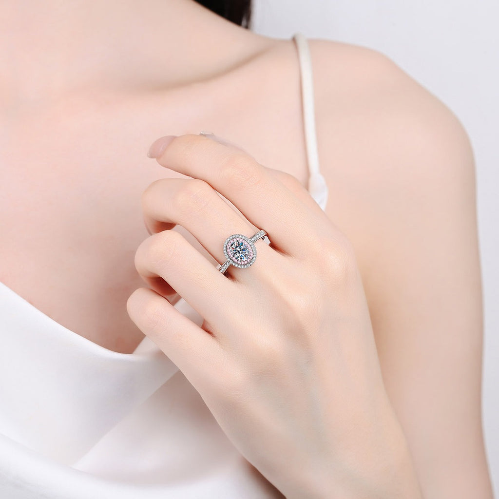 Oval Cut Moissanite Ring with Pink CZ in Rhodium-Plated S925 Sterling Silver worn on hand, showing scale, finger coverage, and rhodium-plated finish