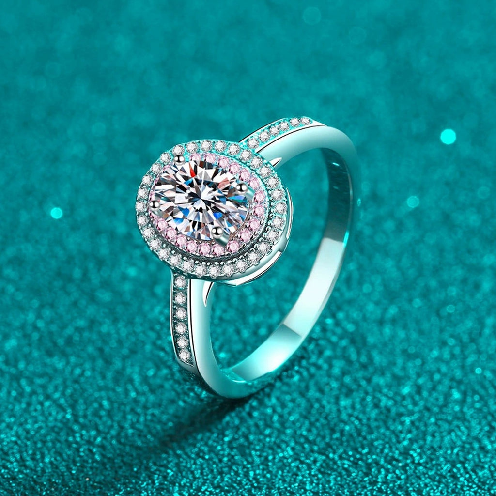 Oval Cut Moissanite Ring with Pink CZ in Rhodium-Plated S925 Sterling Silver blue display product photo showing the moissanite setting, stone cut, and band profile