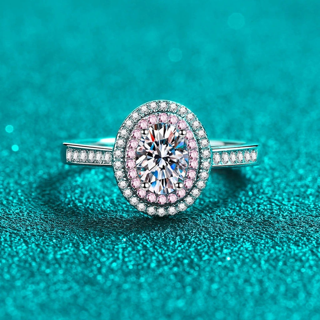 Oval Cut Moissanite Ring with Pink CZ in Rhodium-Plated S925 Sterling Silver blue display product photo showing the moissanite setting, stone cut, and band profile