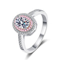 Oval Cut Moissanite Ring with Pink CZ in Rhodium-Plated S925 Sterling Silver clean white background product photo showing the ring silhouette and moissanite setting
