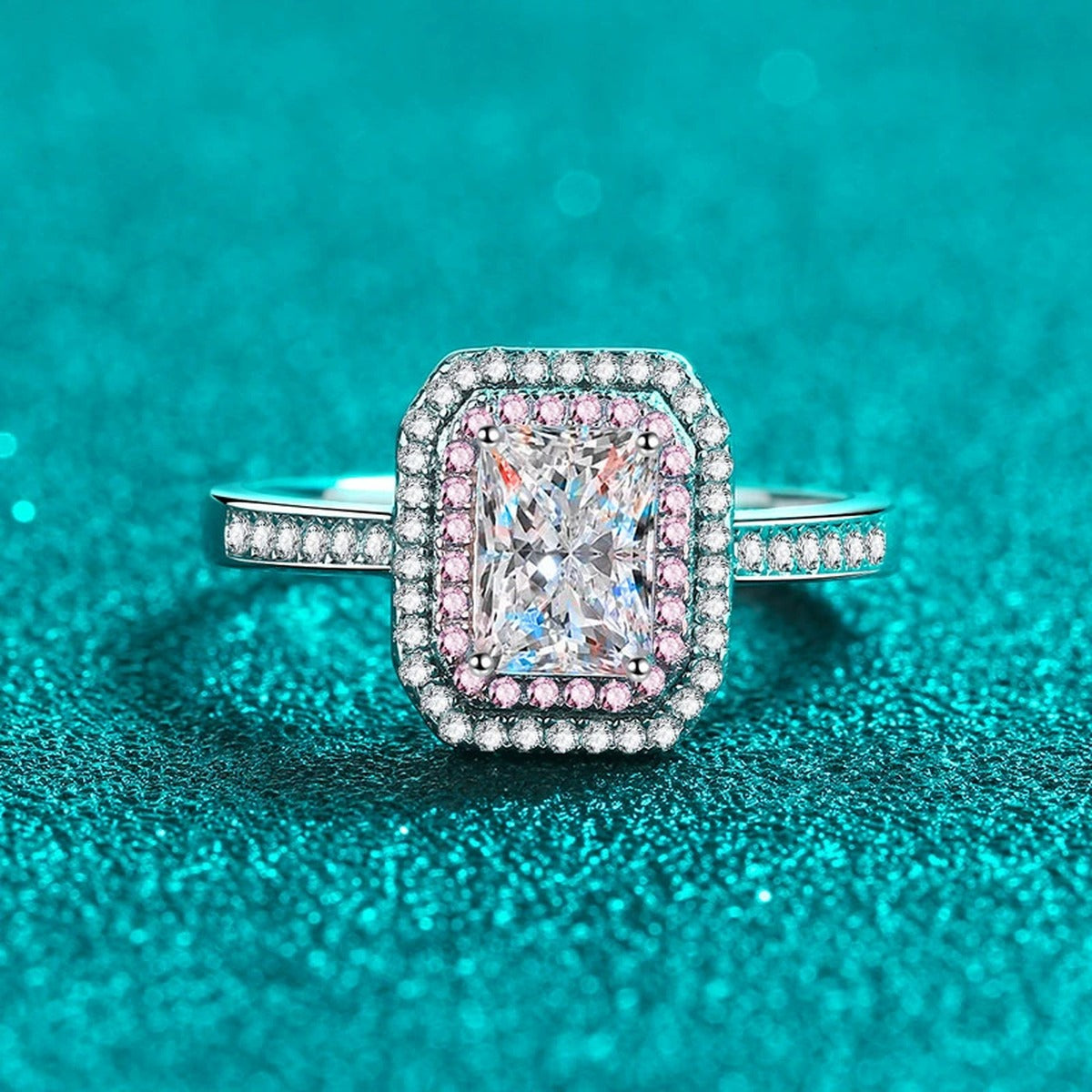 Emerald and Radiant Cut Moissanite Ring with Pink CZ in Rhodium-Plated S925 Sterling Silver blue display product photo showing the moissanite setting, stone cut, and band profile