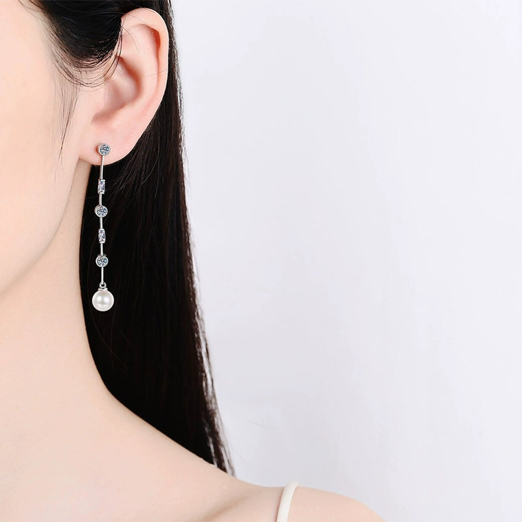 Pearl and Moissanite Stud Dangle Earrings in Rhodium-Plated S925 sterling silver worn on ear by model showing scale, placement, and stud dangle earrings styling