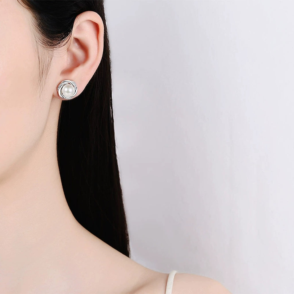 Interlaced Pearl and Moissanite Stud Earrings in Rhodium-Plated S925 sterling silver worn on ear by model showing scale, placement, and stud earrings styling