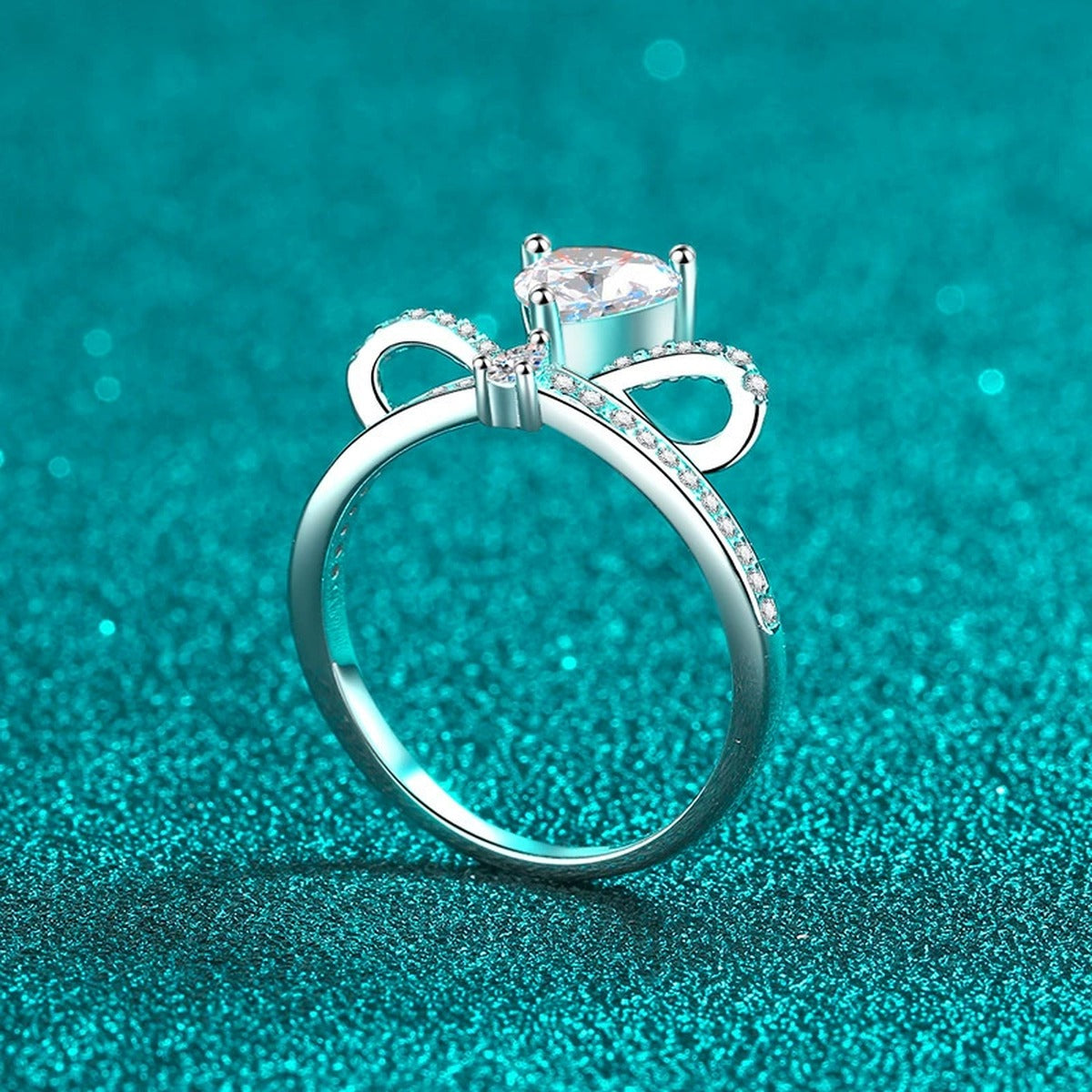 Heart Cut Moissanite Side Stone Engagement Ring with CZ in Rhodium-Plated S925 Sterling Silver blue display product photo showing the moissanite setting, stone cut, and band profile