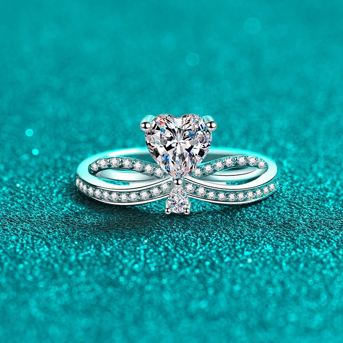 Heart Cut Moissanite Side Stone Engagement Ring with CZ in Rhodium-Plated S925 Sterling Silver blue display product photo showing the moissanite setting, stone cut, and band profile