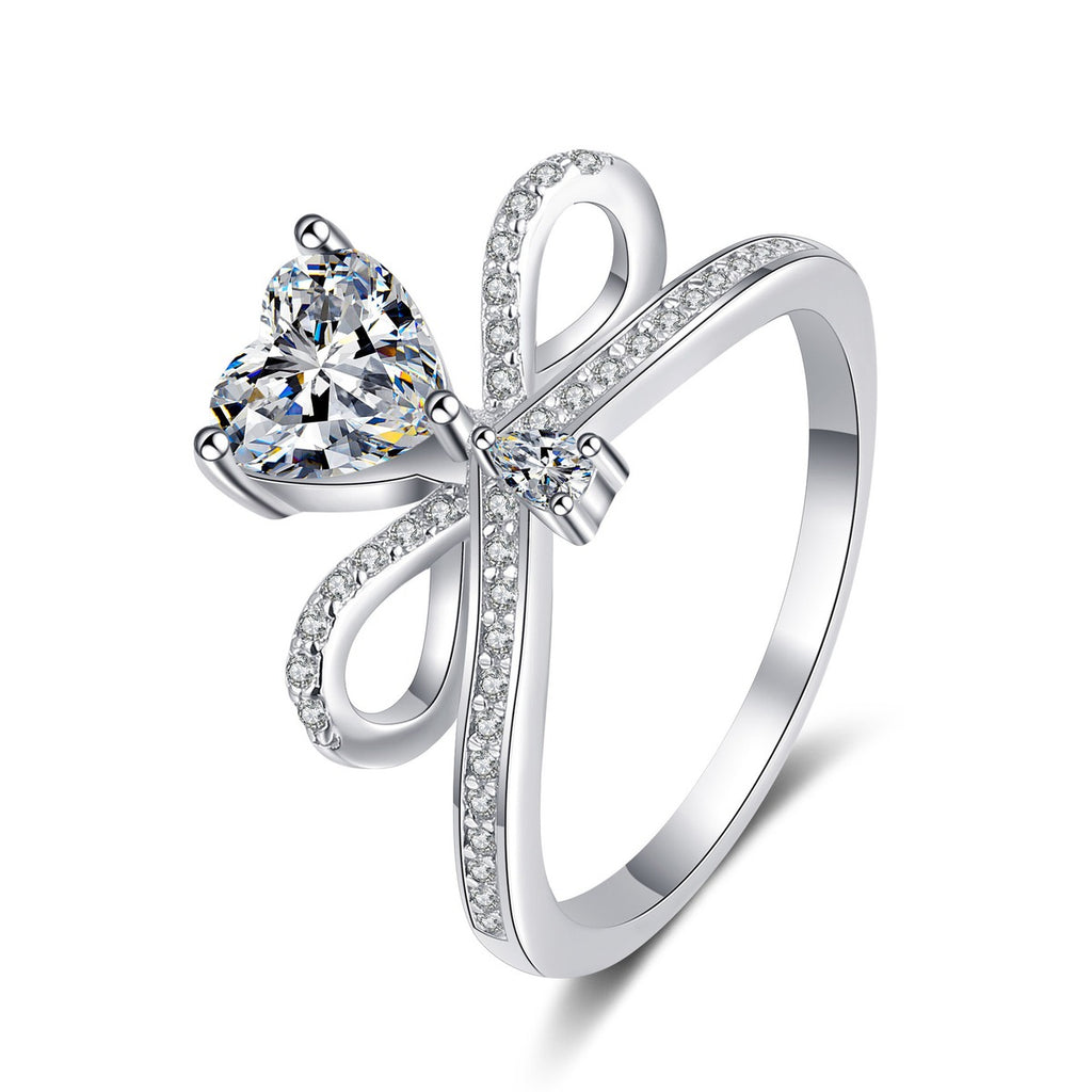 Heart Cut Moissanite Side Stone Engagement Ring with CZ in Rhodium-Plated S925 Sterling Silver clean white background product photo showing the ring silhouette and moissanite setting