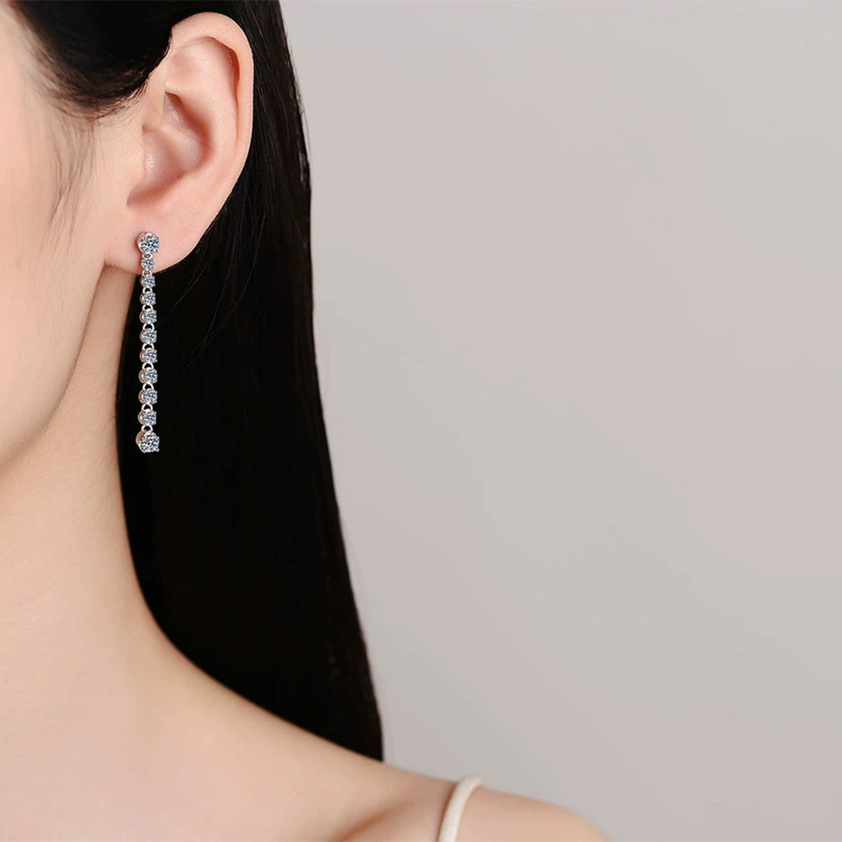 Round Moissanite Stud Dangle Earrings in Rhodium-Plated S925 sterling silver worn on ear by model showing scale, placement, and stud dangle earrings styling