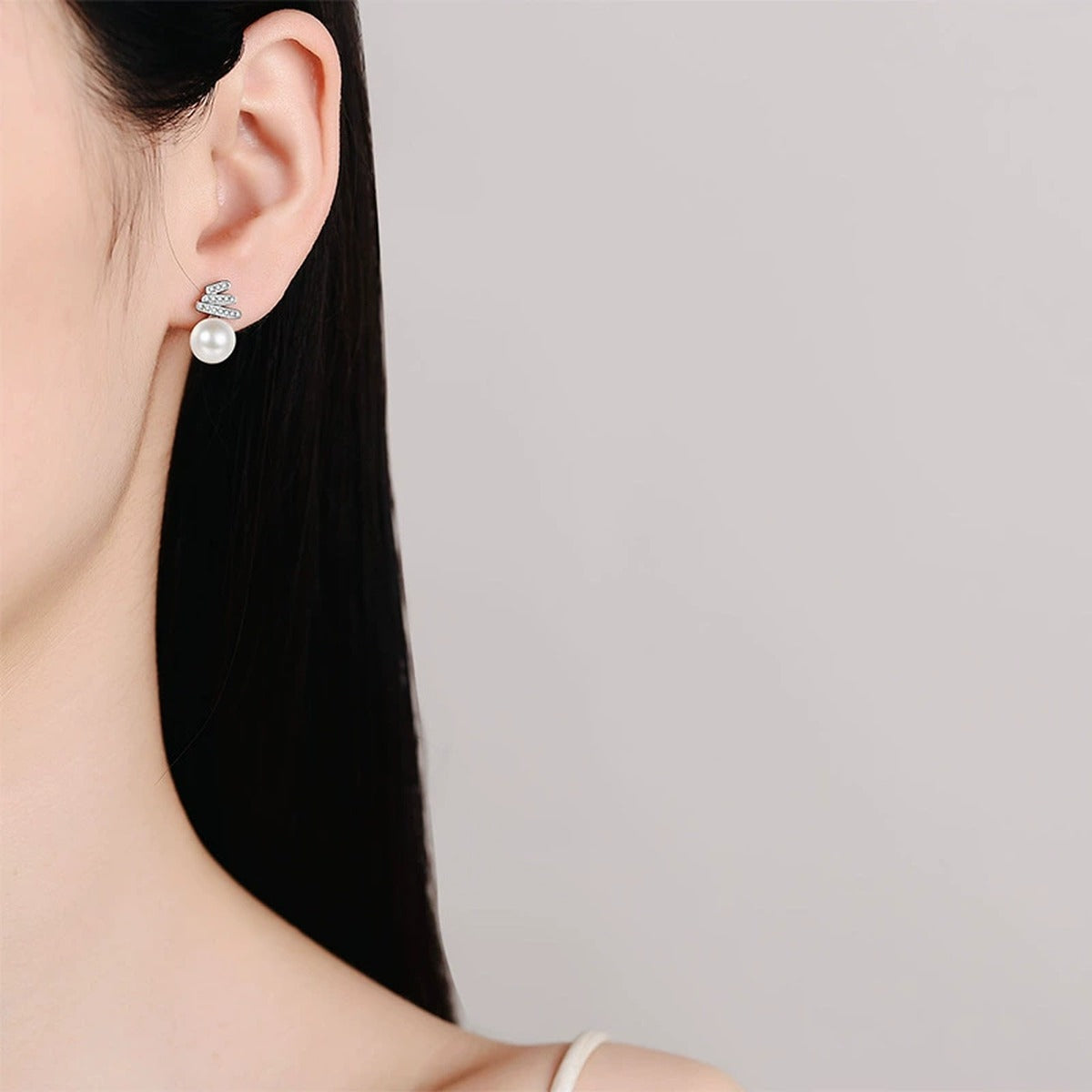 Pearl and Moissanite Stud Drop Earrings in Rhodium-Plated S925 sterling silver worn on ear by model showing scale, placement, and stud earrings styling