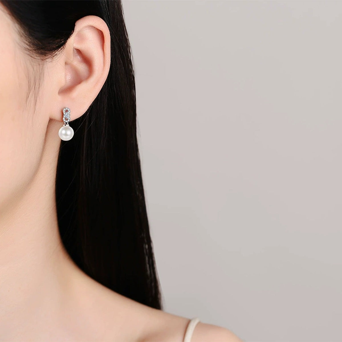 Princess and Round Moissanite Pearl Stud Dangle Earrings in Rhodium-Plated S925 sterling silver worn on ear by model showing scale, placement, and stud dangle earrings styling