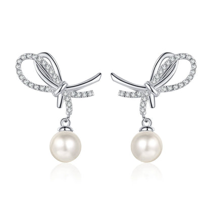 Bow Pearl Moissanite Stud Dangle Earrings in Rhodium-Plated S925 sterling silver on white background showing the full pair, pearl and moissanite detail, and stud dangle earrings silhouette