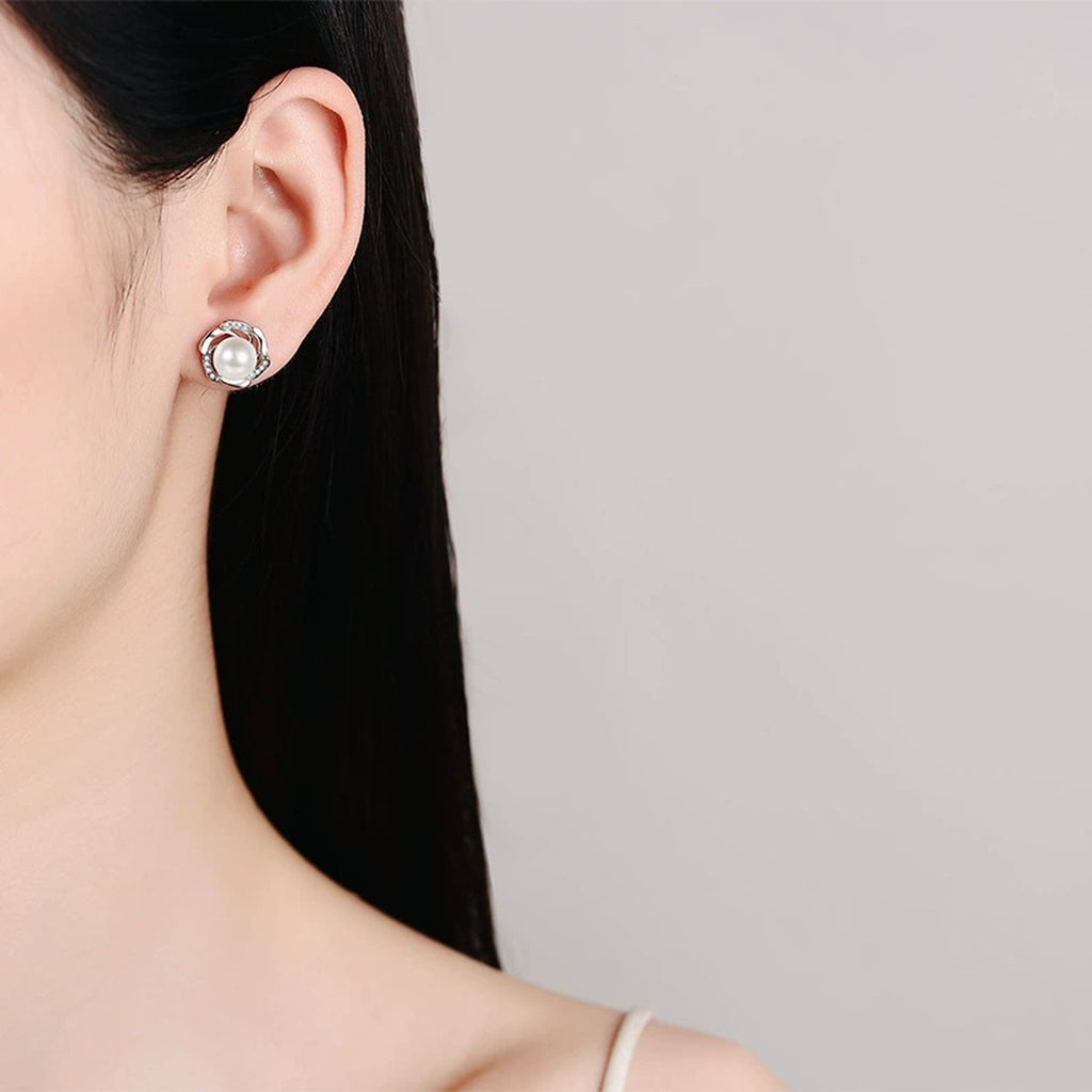 Floral Pearl and Moissanite Stud Earrings in Rhodium-Plated S925 sterling silver worn on ear by model showing scale, placement, and stud earrings styling