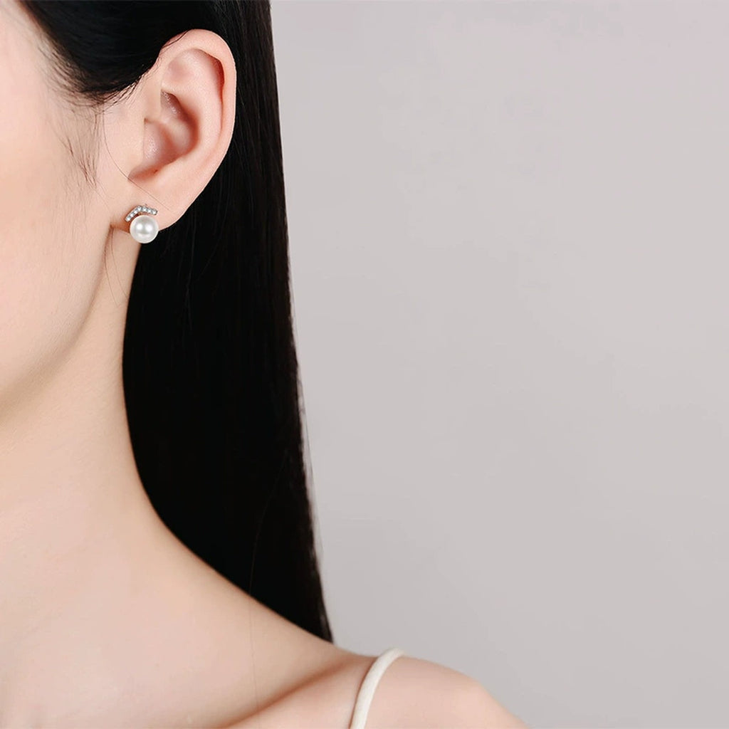 Pearl and Moissanite Bar Stud Earrings in Rhodium-Plated S925 sterling silver worn on ear by model showing scale, placement, and stud earrings styling