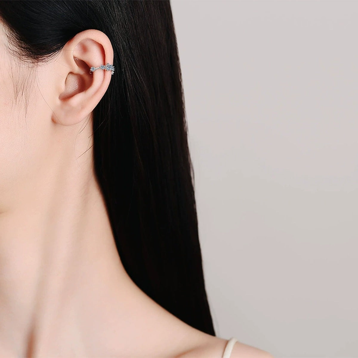 Pave Moissanite Ear Cuff Earrings in Rhodium-Plated S925 sterling silver worn on ear by model showing scale, placement, and ear cuff earrings styling