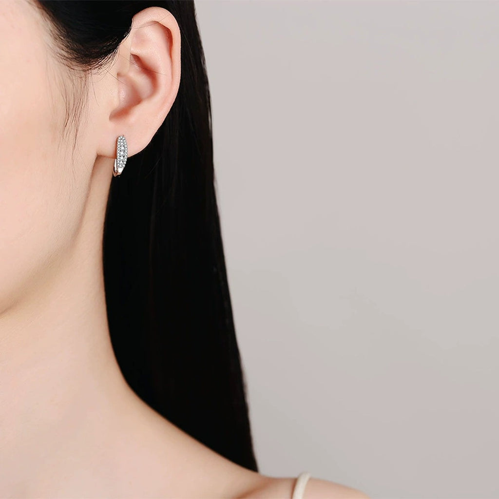 Pavé Moissanite Hoop Earrings in Rhodium-Plated S925 sterling silver worn on ear by model showing scale, placement, and hoop earrings styling
