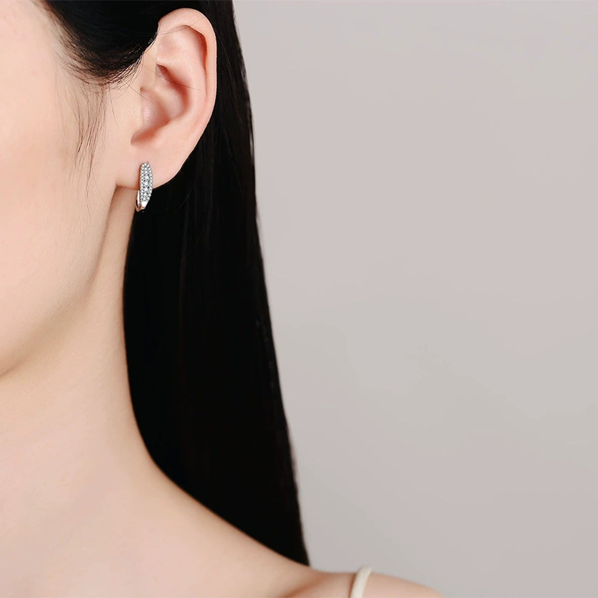 Pavé Moissanite Hoop Earrings in Rhodium-Plated S925 sterling silver worn on ear by model showing scale, placement, and hoop earrings styling