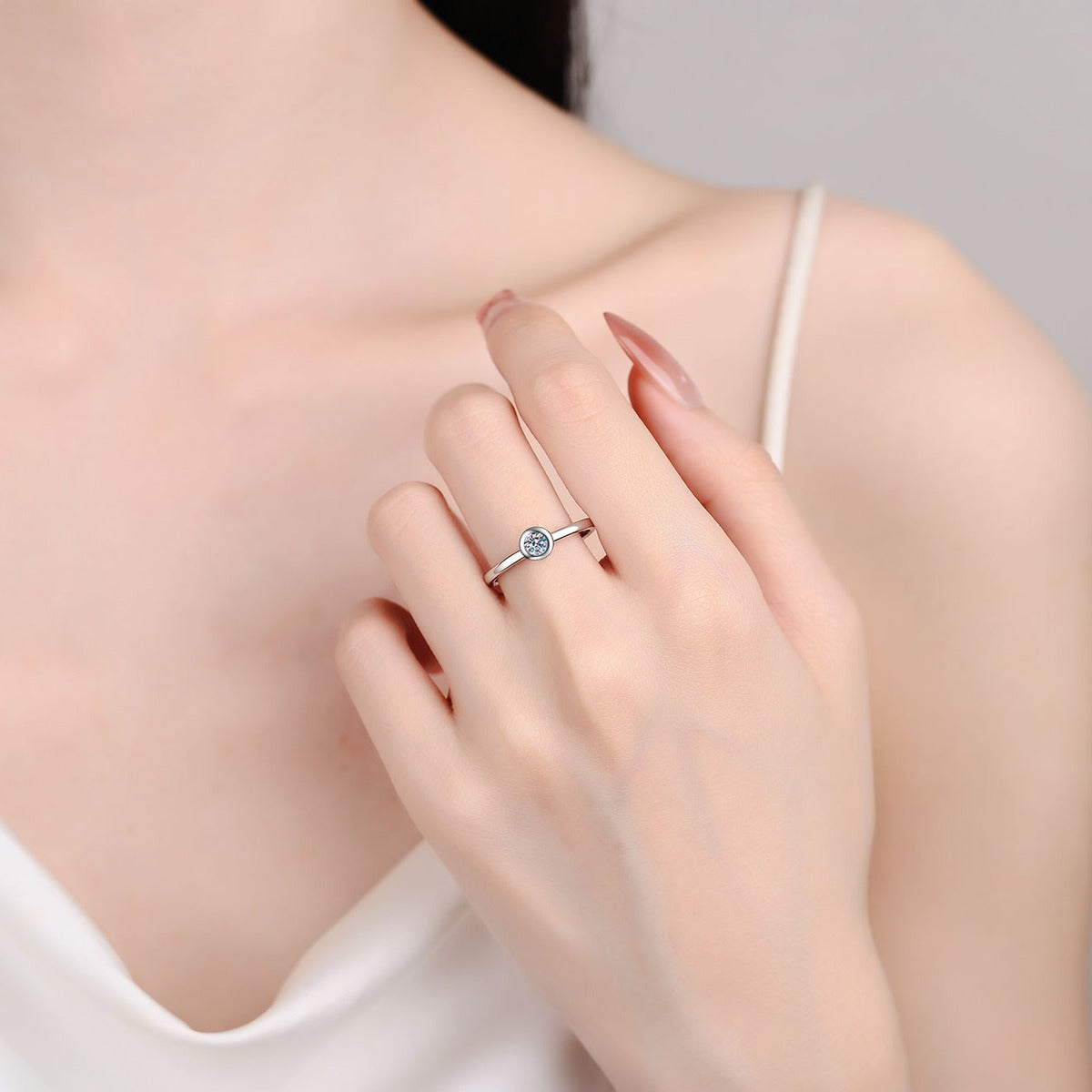 Round Moissanite Solitaire Ring worn on hand to show scale, band width, and ring profile