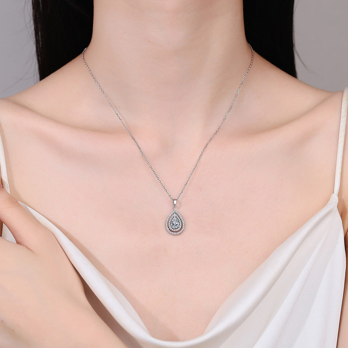 Pear Cut Halo Moissanite Pendant Necklace with CZ in Rhodium-Plated S925 sterling silver neckline model view showing pendant scale and chain length
