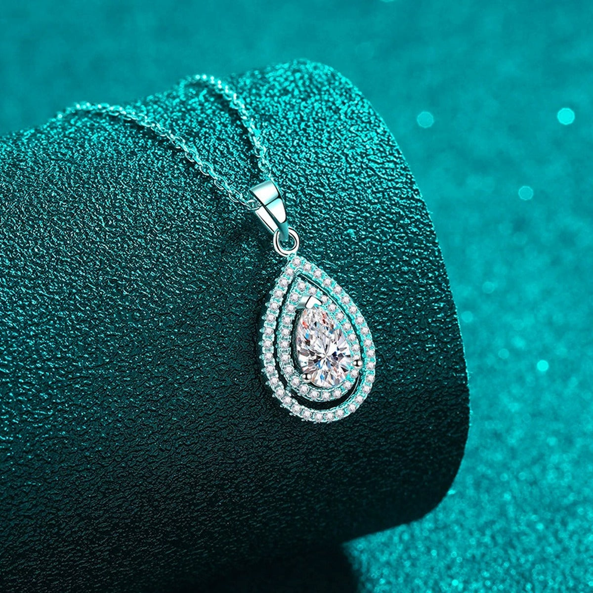 Pear Cut Halo Moissanite Pendant Necklace with CZ in Rhodium-Plated S925 sterling silver close-up product scene showing pendant setting