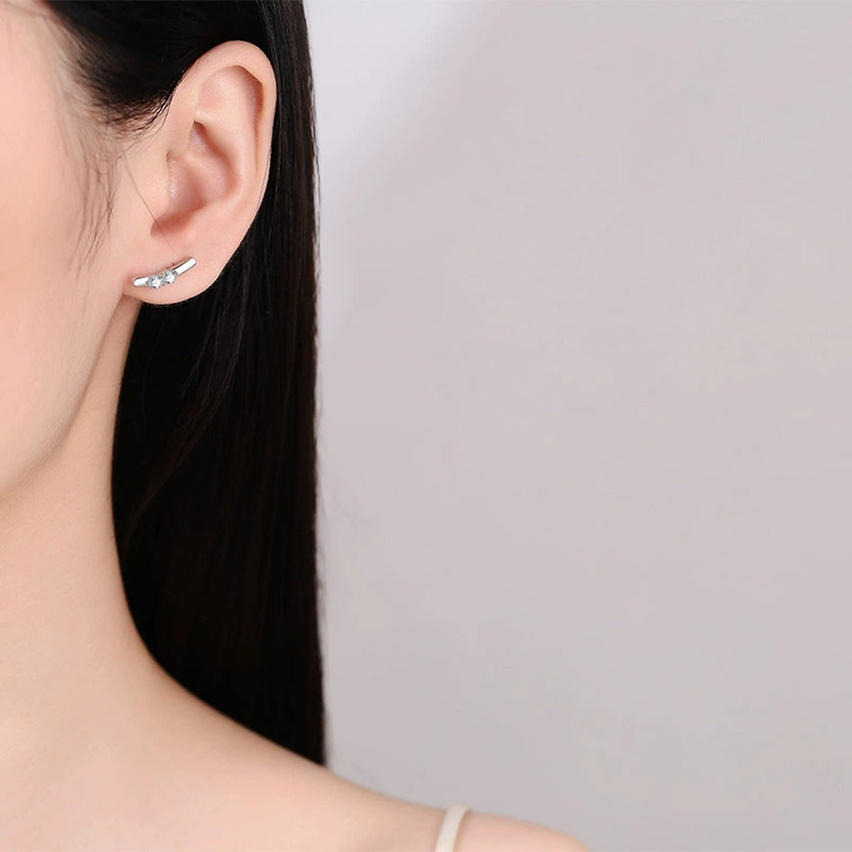 Round Moissanite Stud Ear Climber Earrings in Rhodium-Plated S925 sterling silver worn on ear by model showing scale, placement, and stud earrings styling