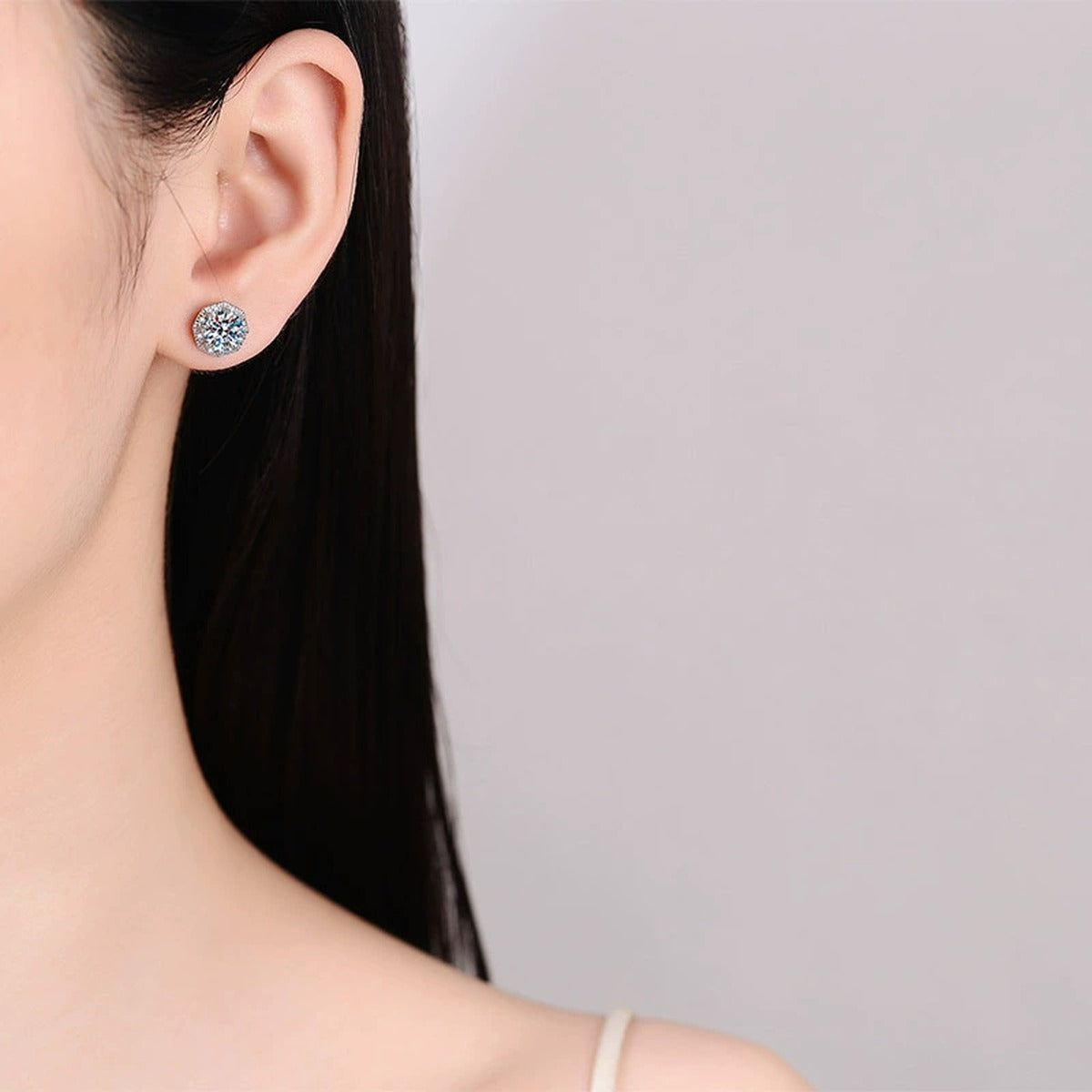 Round Halo Moissanite Stud Earrings with CZ in Rhodium-Plated S925 sterling silver worn on ear by model showing scale, placement, and stud earrings styling