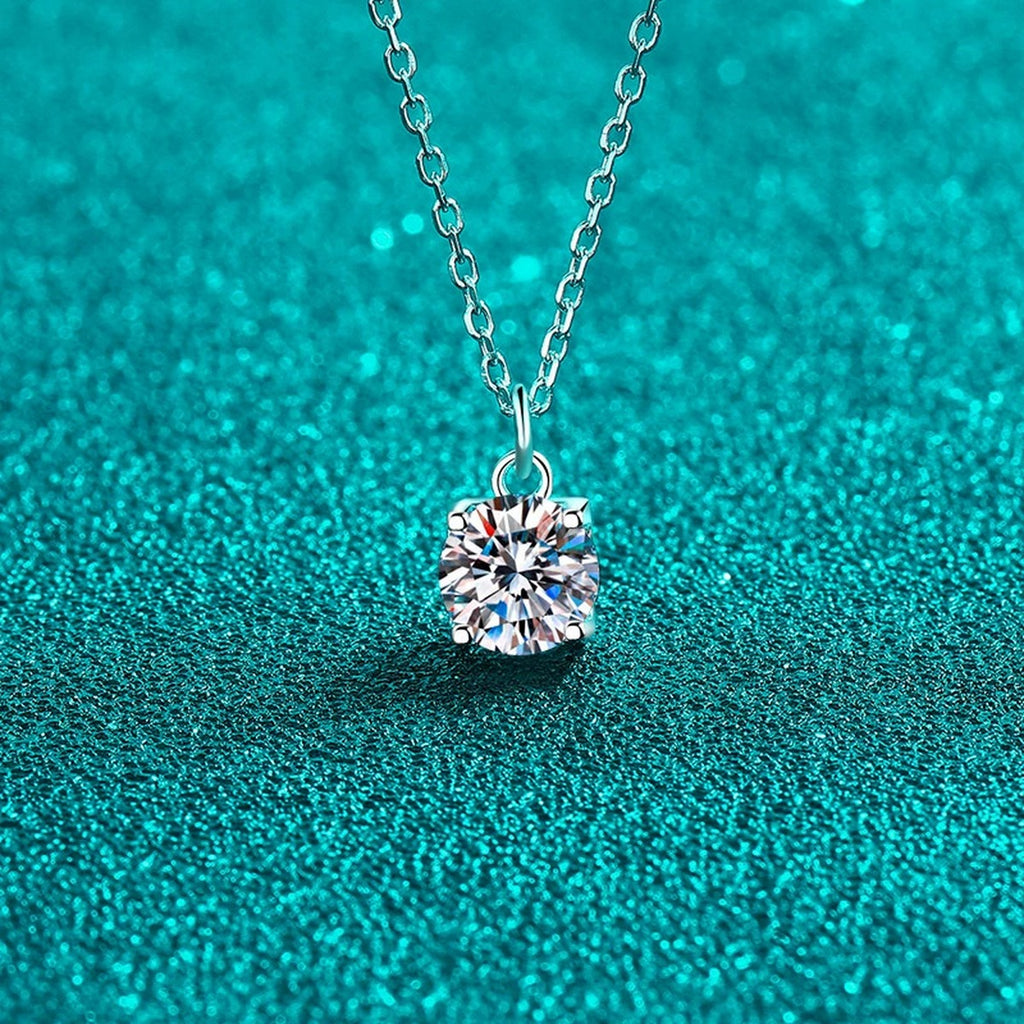 Round Solitaire Moissanite Pendant Necklace in Rhodium-Plated S925 sterling silver blue display scene showing chain and stone layout