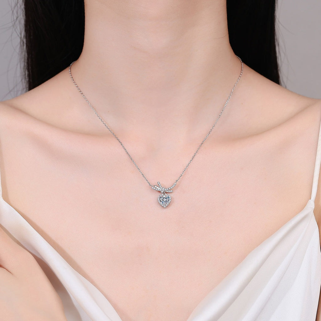 Heart Bow Moissanite Pendant Necklace with CZ in Rhodium-Plated S925 sterling silver neckline model view showing pendant scale and chain length
