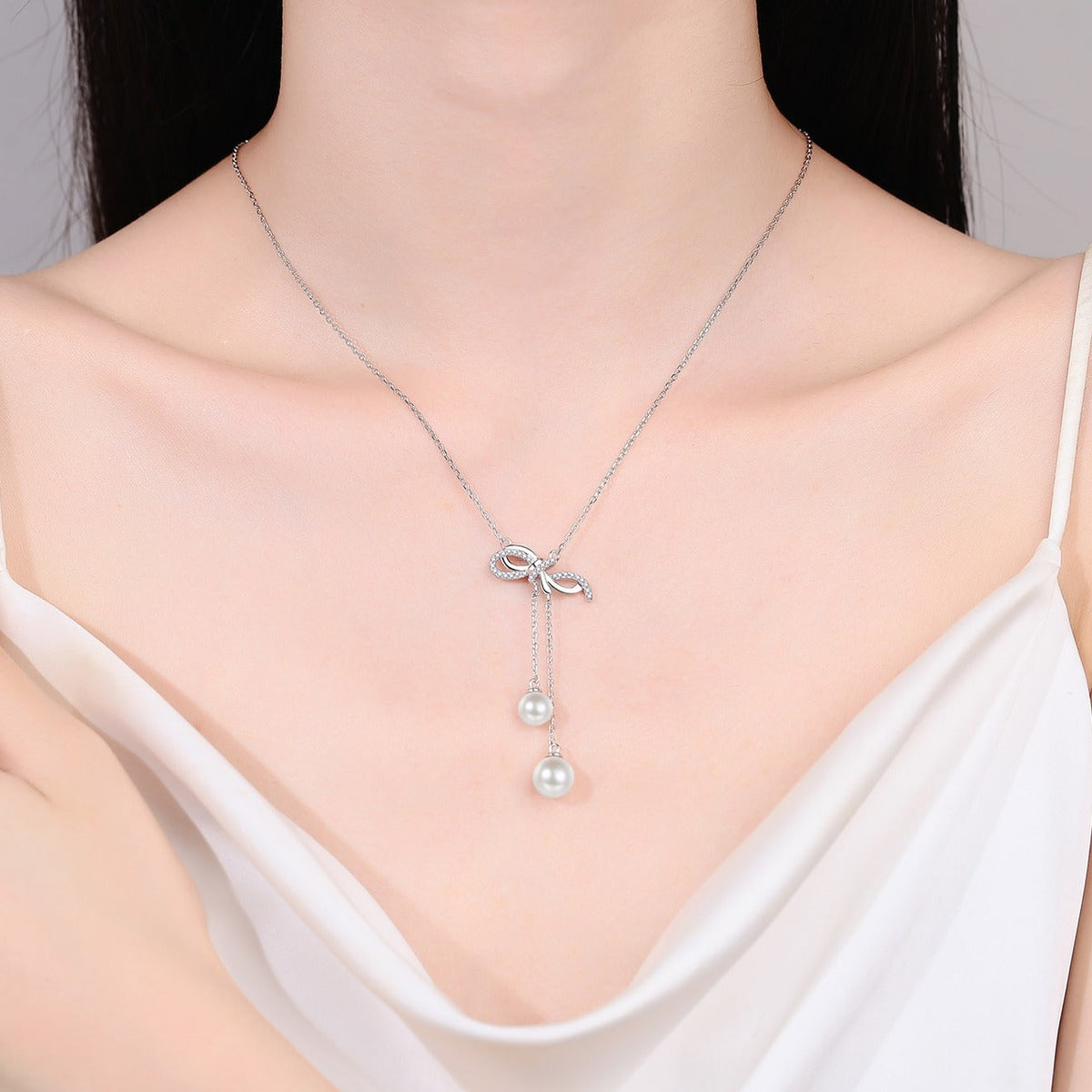 Bow Lariat Moissanite Pearl Necklace in Rhodium-Plated S925 sterling silver neckline model view showing pendant scale and adjustable chain