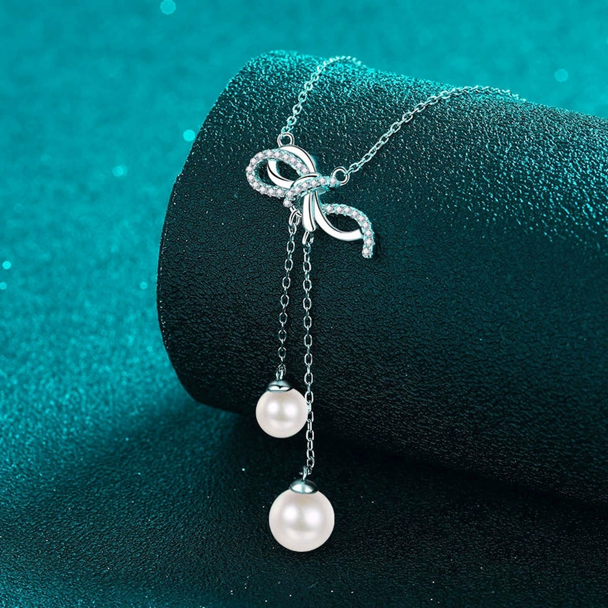 Bow Lariat Moissanite Pearl Necklace in Rhodium-Plated S925 sterling silver blue display scene showing chain and stone layout