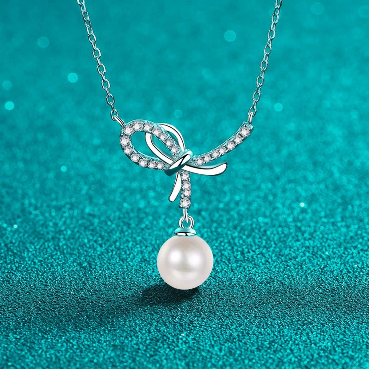Bow Moissanite Pearl Pendant Necklace in Rhodium-Plated S925 sterling silver close-up product scene showing pendant setting