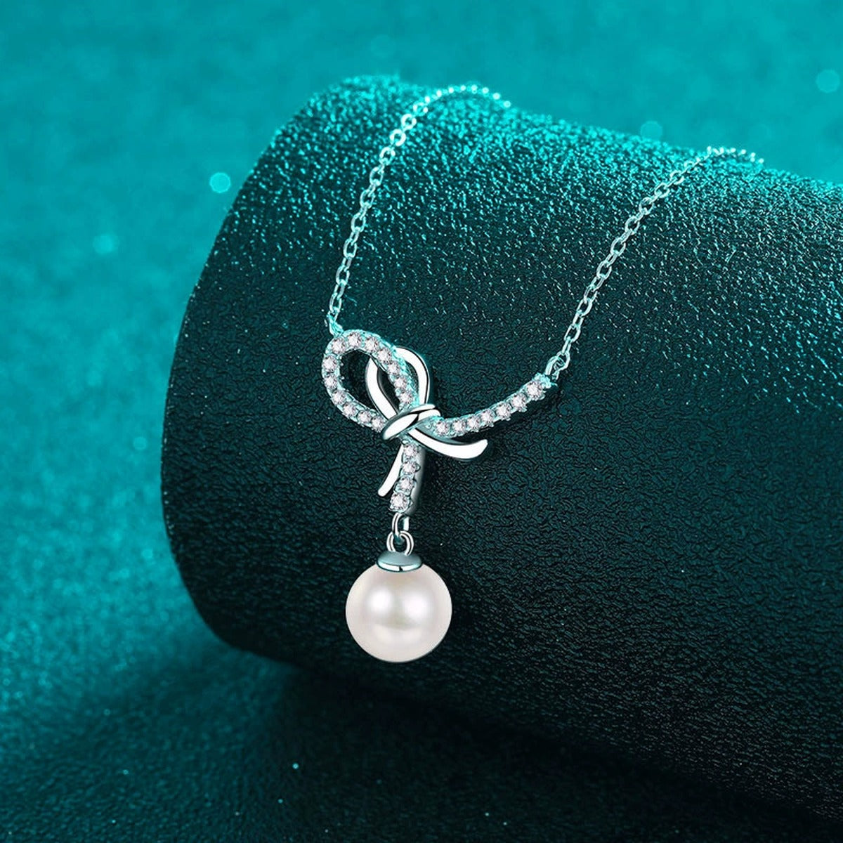 Bow Moissanite Pearl Pendant Necklace in Rhodium-Plated S925 sterling silver angled product detail view