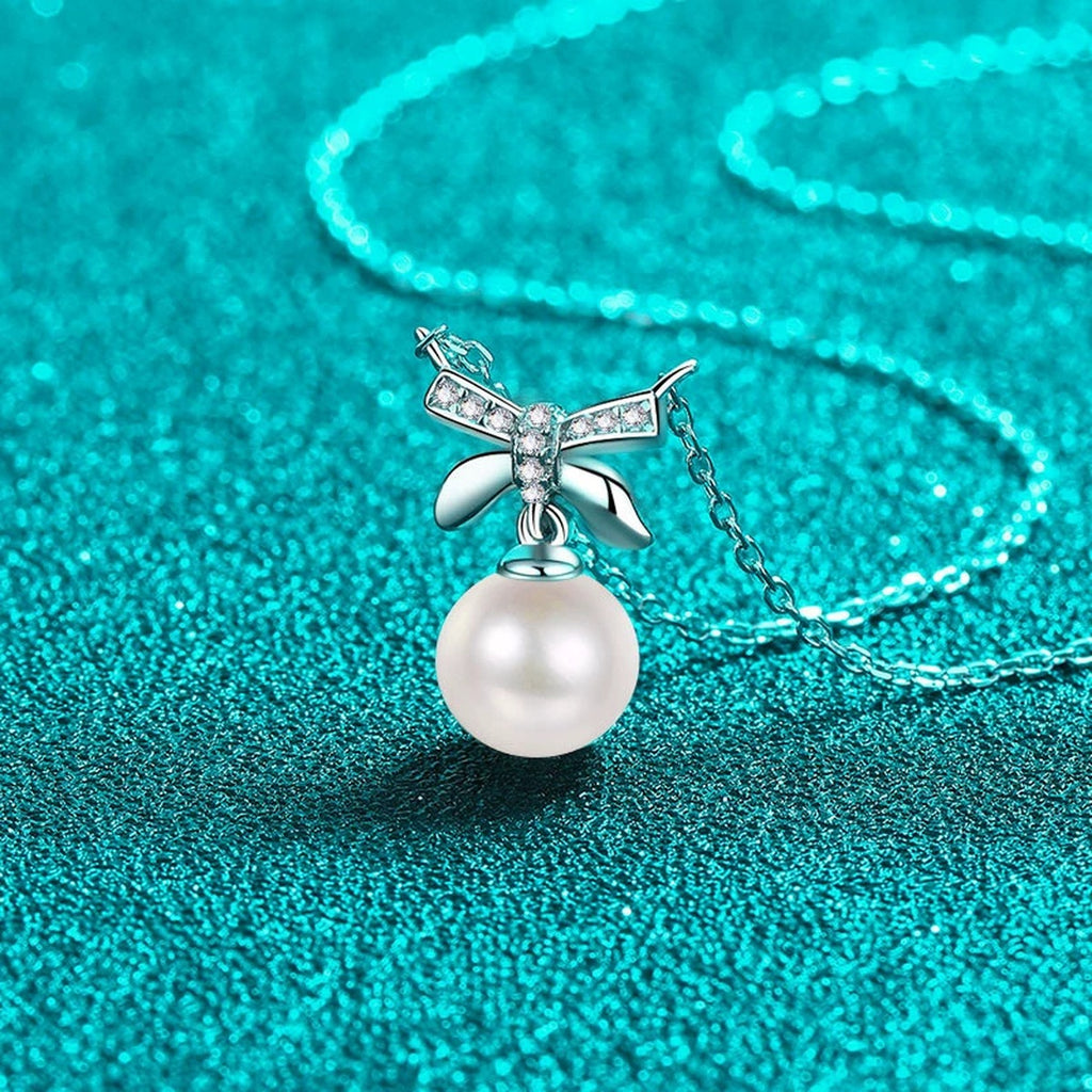 Bow Moissanite Pearl Pendant Necklace in Rhodium-Plated S925 sterling silver blue display scene showing chain and stone layout