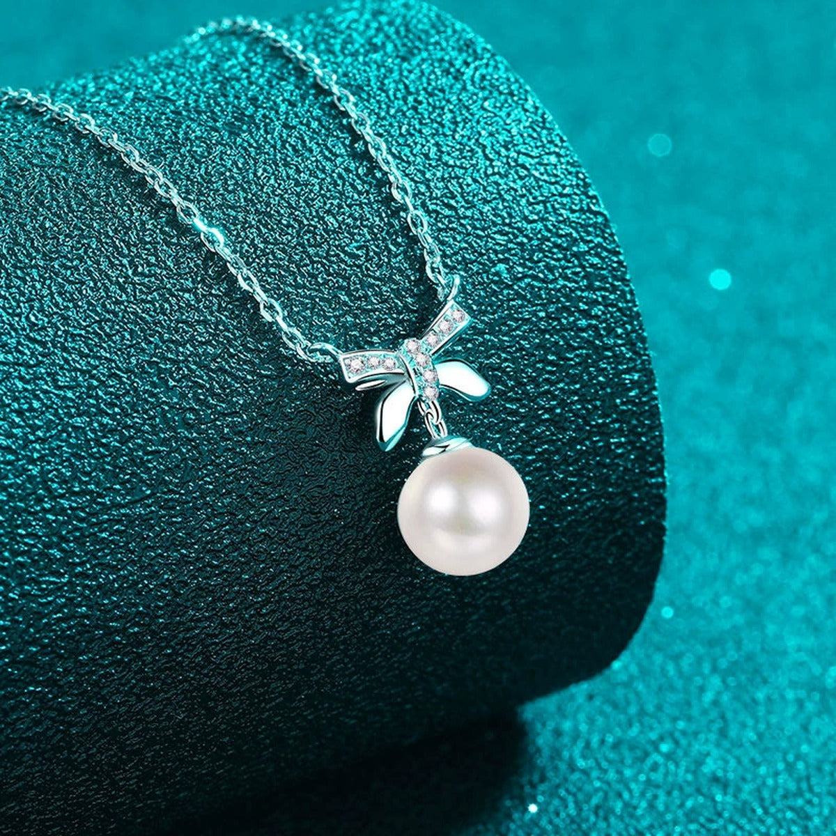 Bow Moissanite Pearl Pendant Necklace in Rhodium-Plated S925 sterling silver angled product detail view
