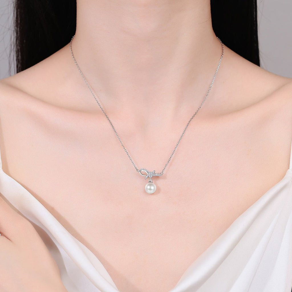 Ribbon Bow Moissanite Pearl Necklace in Rhodium-Plated S925 sterling silver neckline model view showing pendant scale and adjustable chain