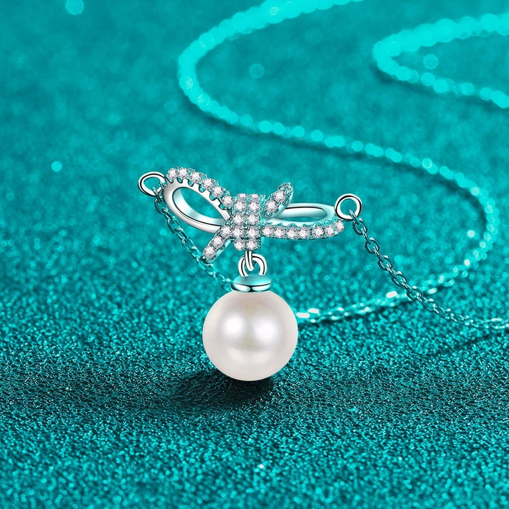 Ribbon Bow Moissanite Pearl Necklace in Rhodium-Plated S925 sterling silver blue display scene showing chain and stone layout