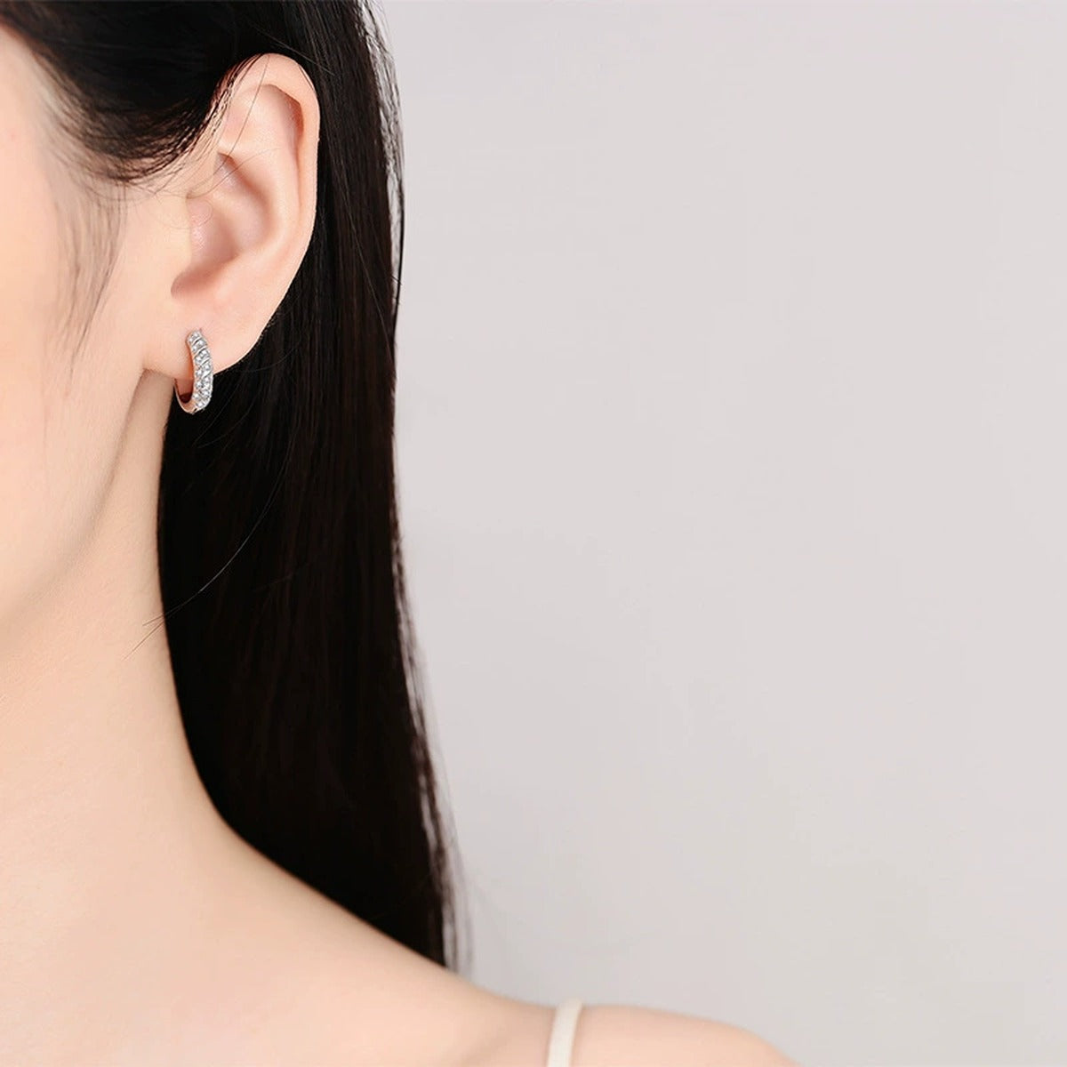 Pave Moissanite Hoop Earrings in Rhodium-Plated S925 sterling silver worn on ear by model showing scale, placement, and hoop earrings styling