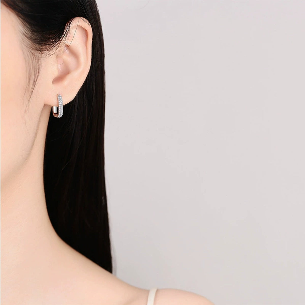 Slim Pave Moissanite Hoop Earrings in Rhodium-Plated S925 sterling silver worn on ear by model showing scale, placement, and hoop earrings styling