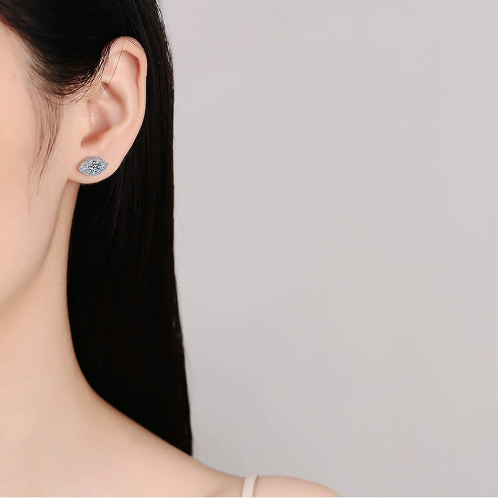 Marquise Halo Round Moissanite Stud Earrings with CZ in Rhodium-Plated S925 sterling silver worn on ear by model showing scale, placement, and stud earrings styling