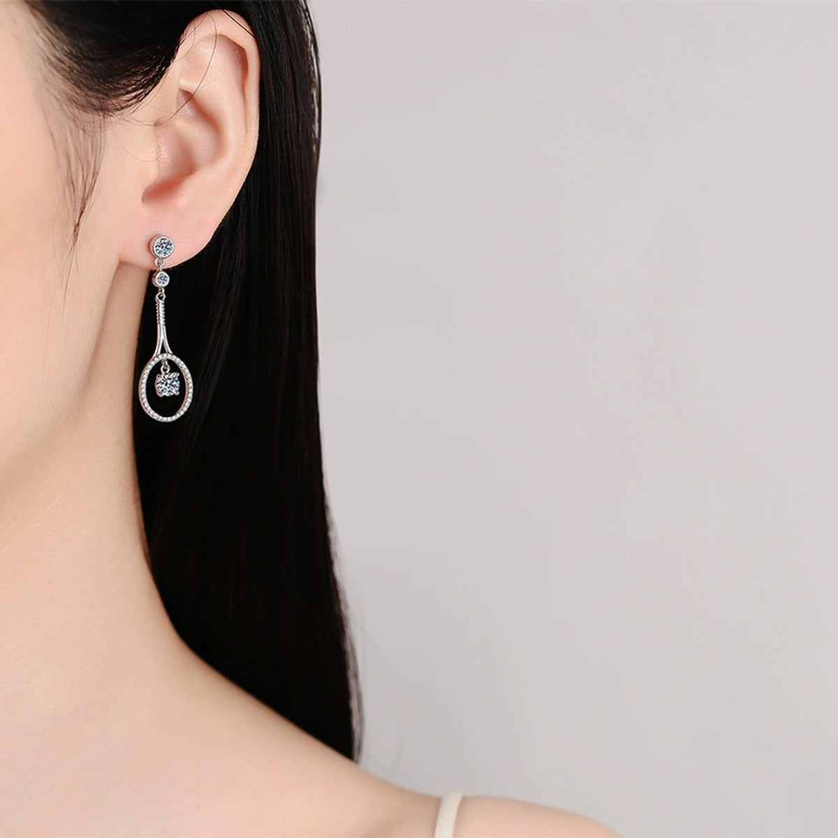 Teardrop Moissanite Stud Dangle Earrings with CZ in Rhodium-Plated S925 sterling silver worn on ear by model showing scale, placement, and stud dangle earrings styling