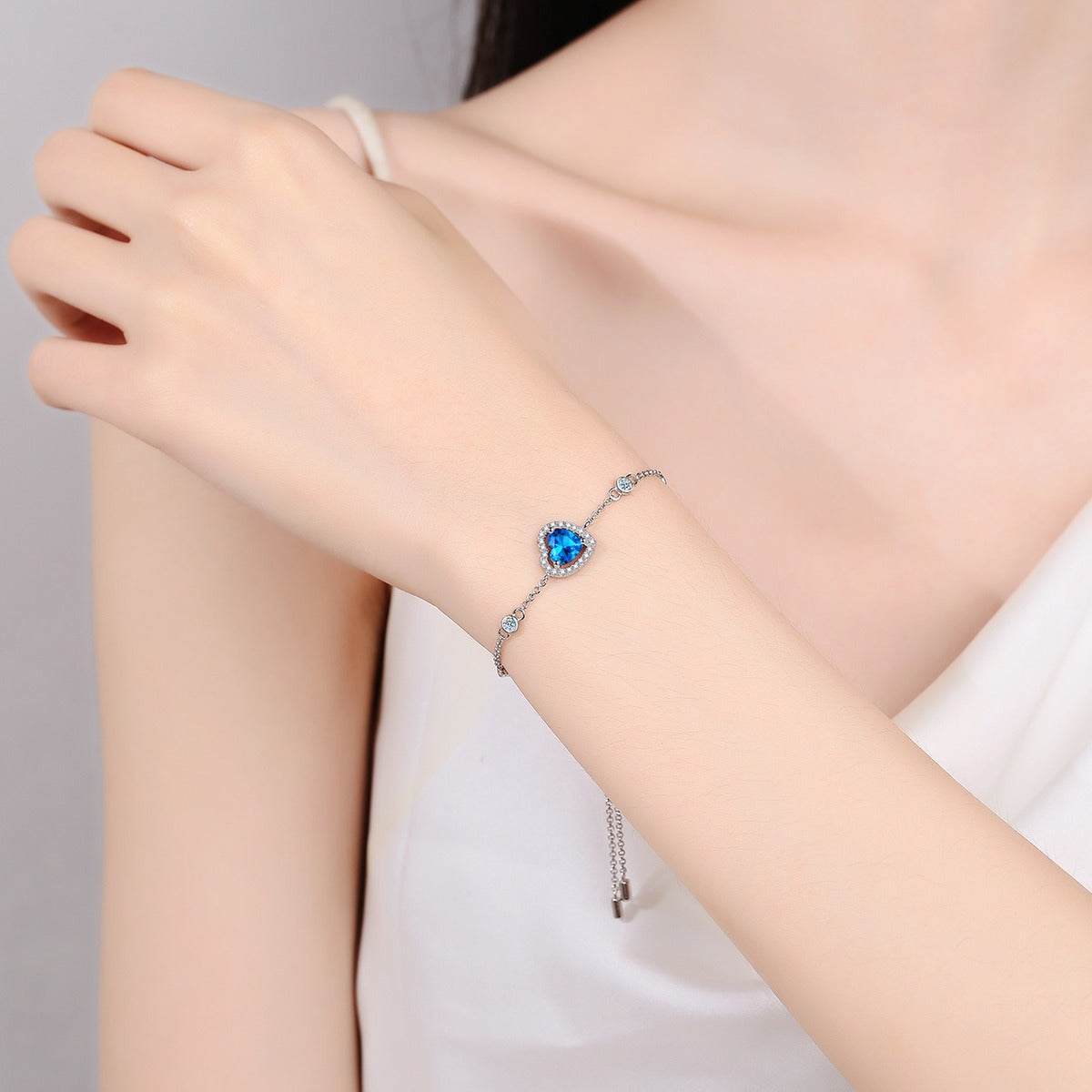 Heart Moissanite Adjustable Bracelet with CZ in Rhodium-Plated S925 sterling silver worn on wrist model view showing scale and adjustable fit