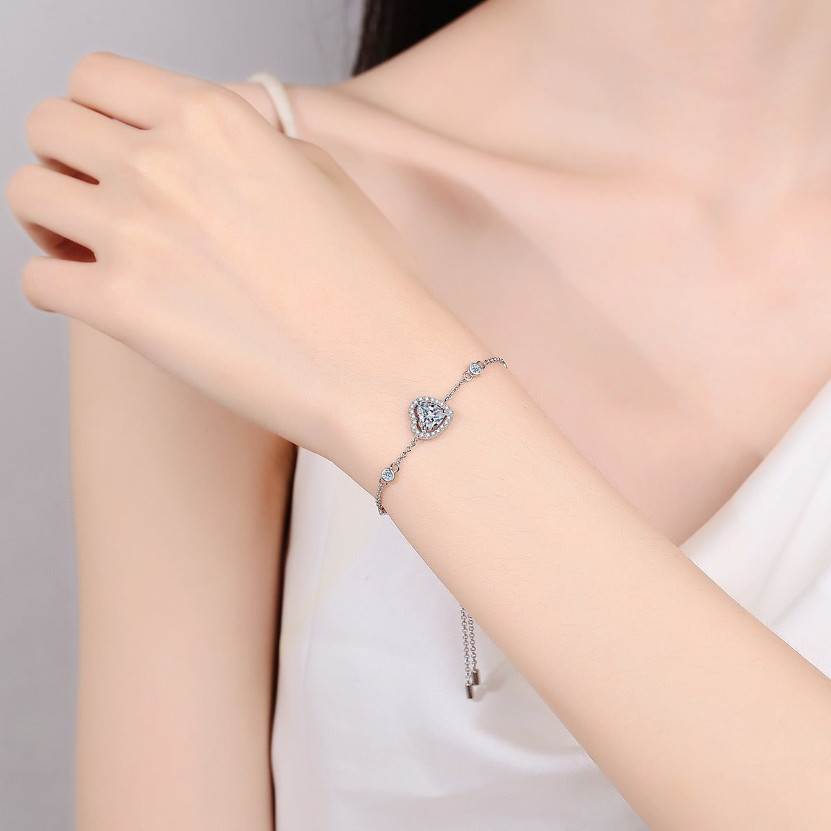 Heart Moissanite Adjustable Bracelet with CZ in Rhodium-Plated S925 sterling silver worn on wrist model view showing scale and adjustable fit