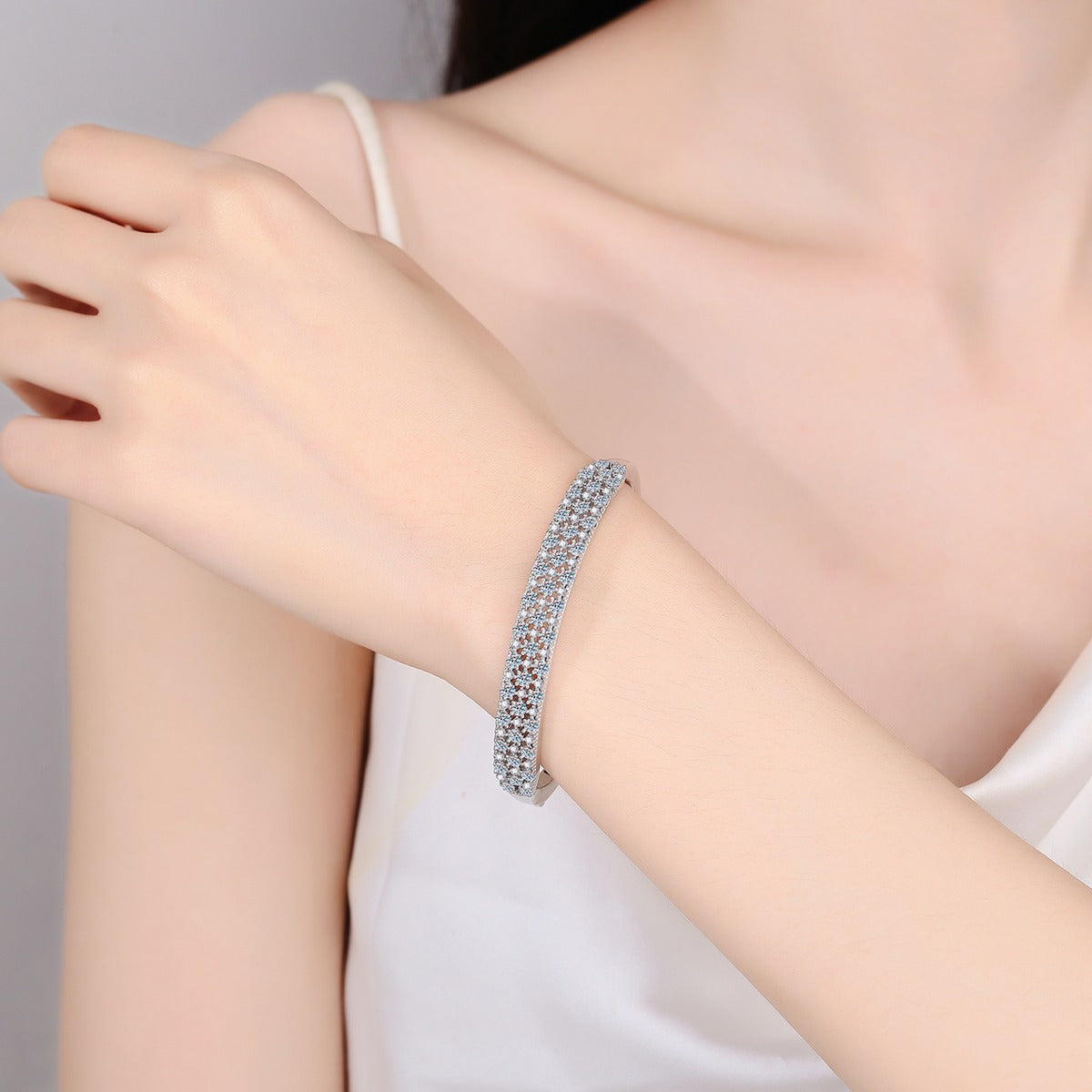 Wide Round Moissanite Pave Bangle in Rhodium-Plated S925 sterling silver worn on wrist model view showing bangle scale and fit