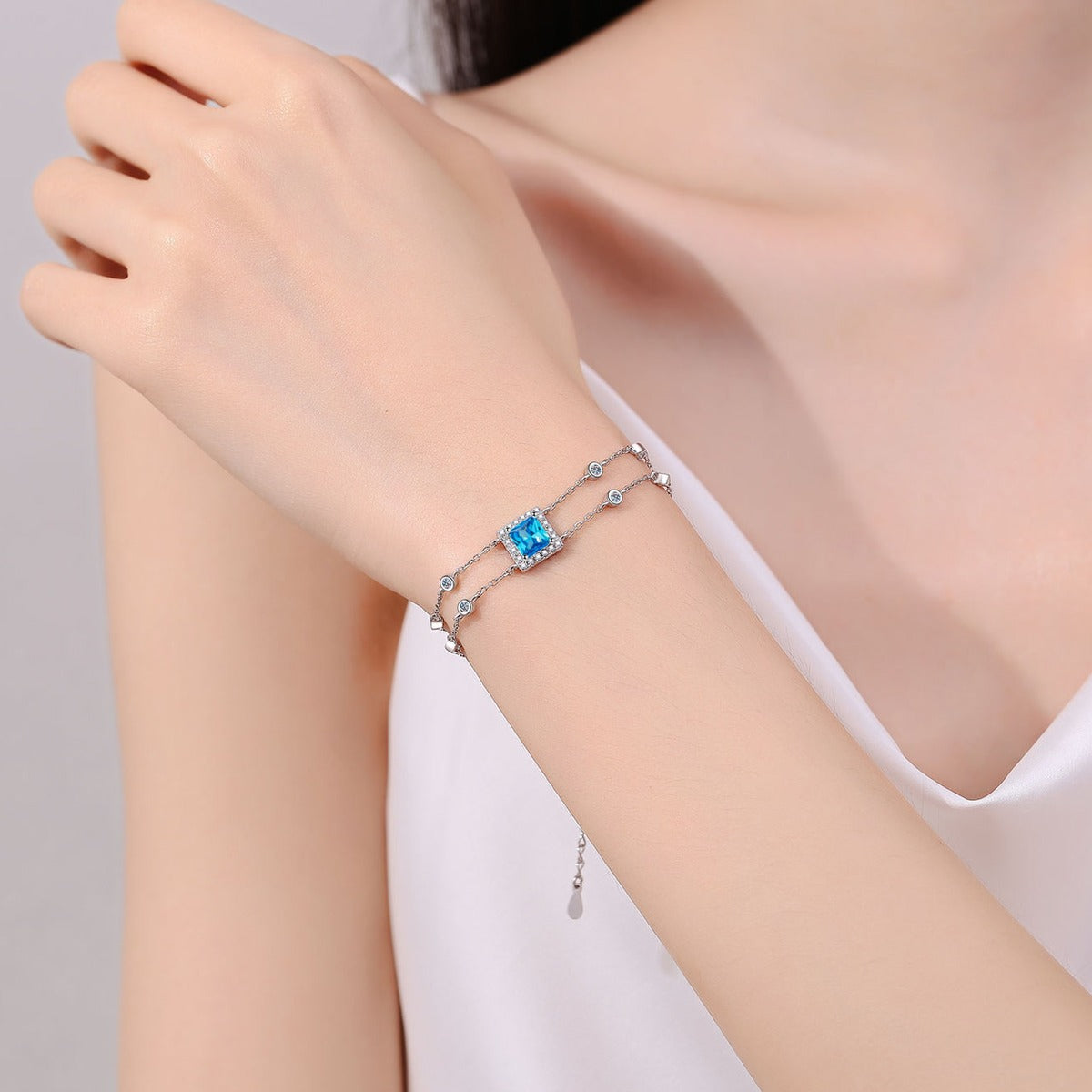 Princess Moissanite Charm Bracelet with CZ in Rhodium-Plated S925 sterling silver worn on wrist model view showing scale and adjustable fit