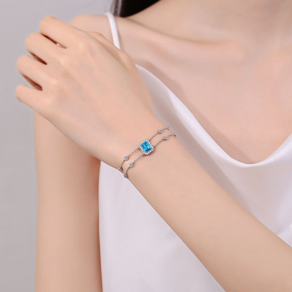 Emerald and Radiant Moissanite Charm Bracelet with CZ in Rhodium-Plated S925 sterling silver worn on wrist model view showing scale and adjustable fit