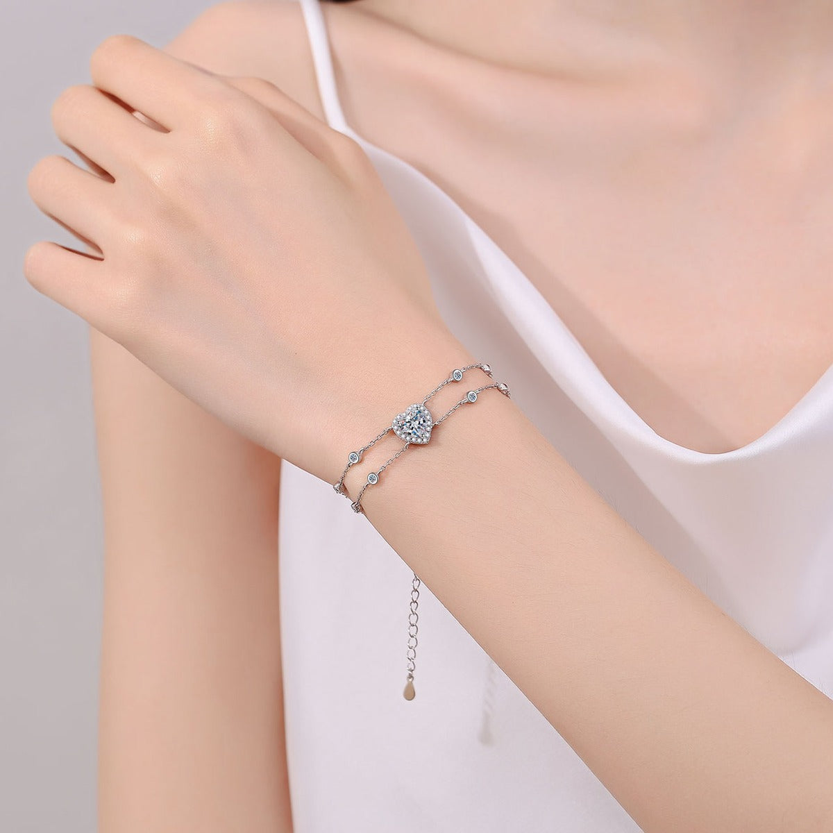 Heart Moissanite Charm Bracelet with CZ in Rhodium-Plated S925 sterling silver worn on wrist model view showing scale and adjustable fit