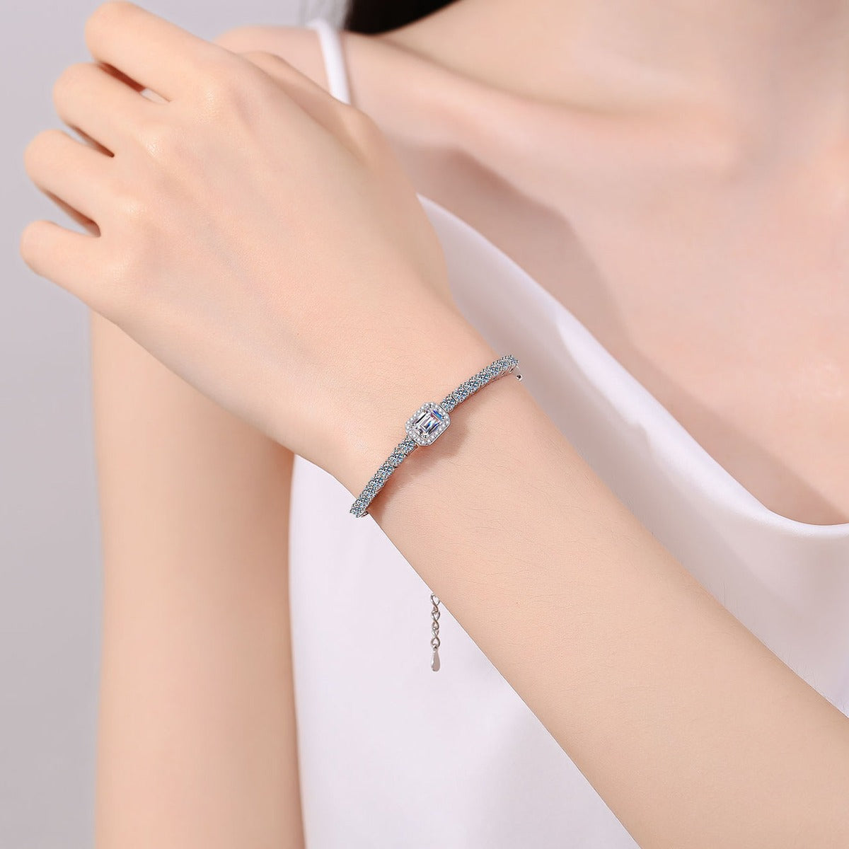 Emerald and Radiant Moissanite Tennis Bracelet with CZ in Rhodium-Plated S925 sterling silver worn on wrist model view showing scale and adjustable fit