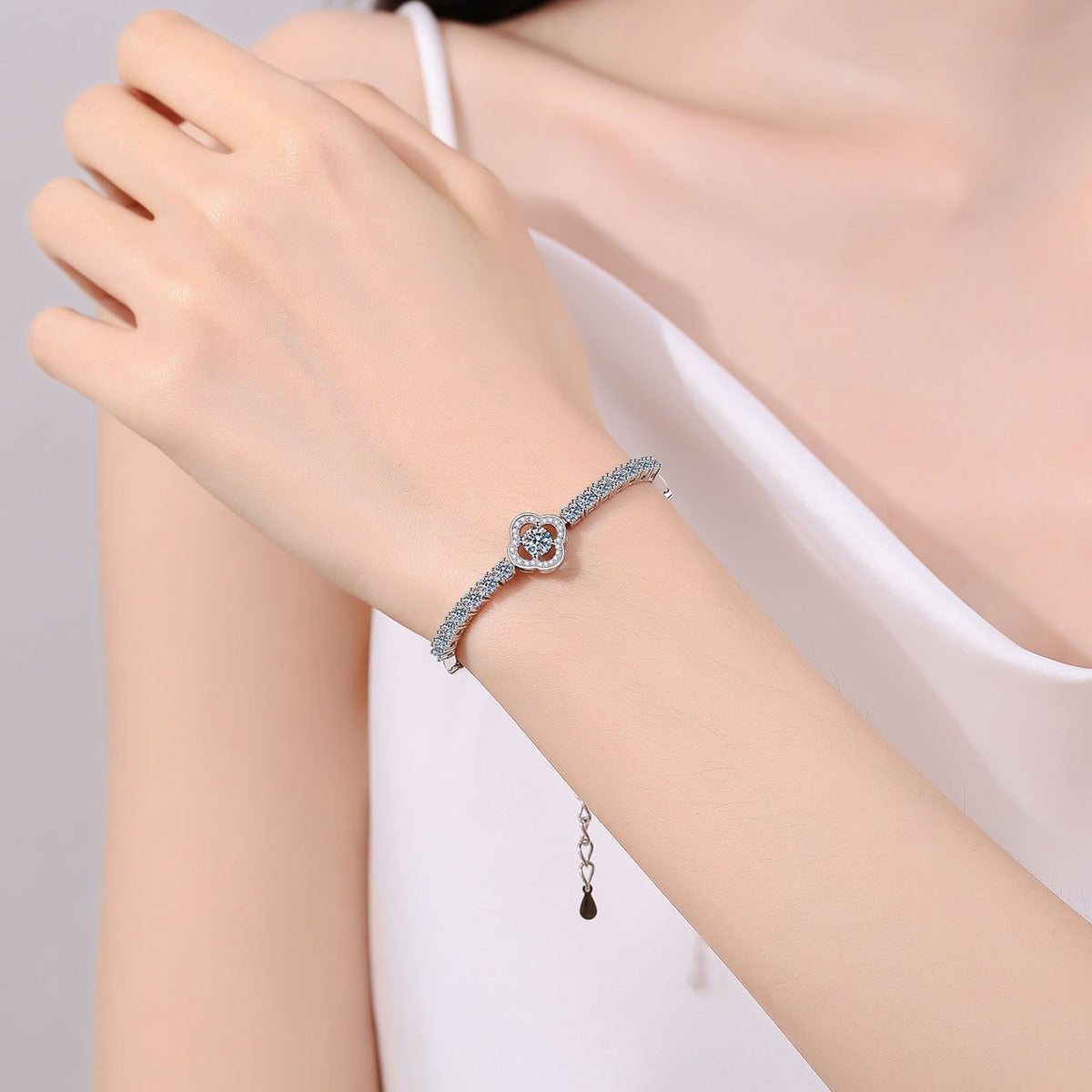 Four-Leaf Clover Moissanite Adjustable Tennis Bracelet with CZ in Rhodium-Plated S925 sterling silver worn on wrist model view showing scale and adjustable fit